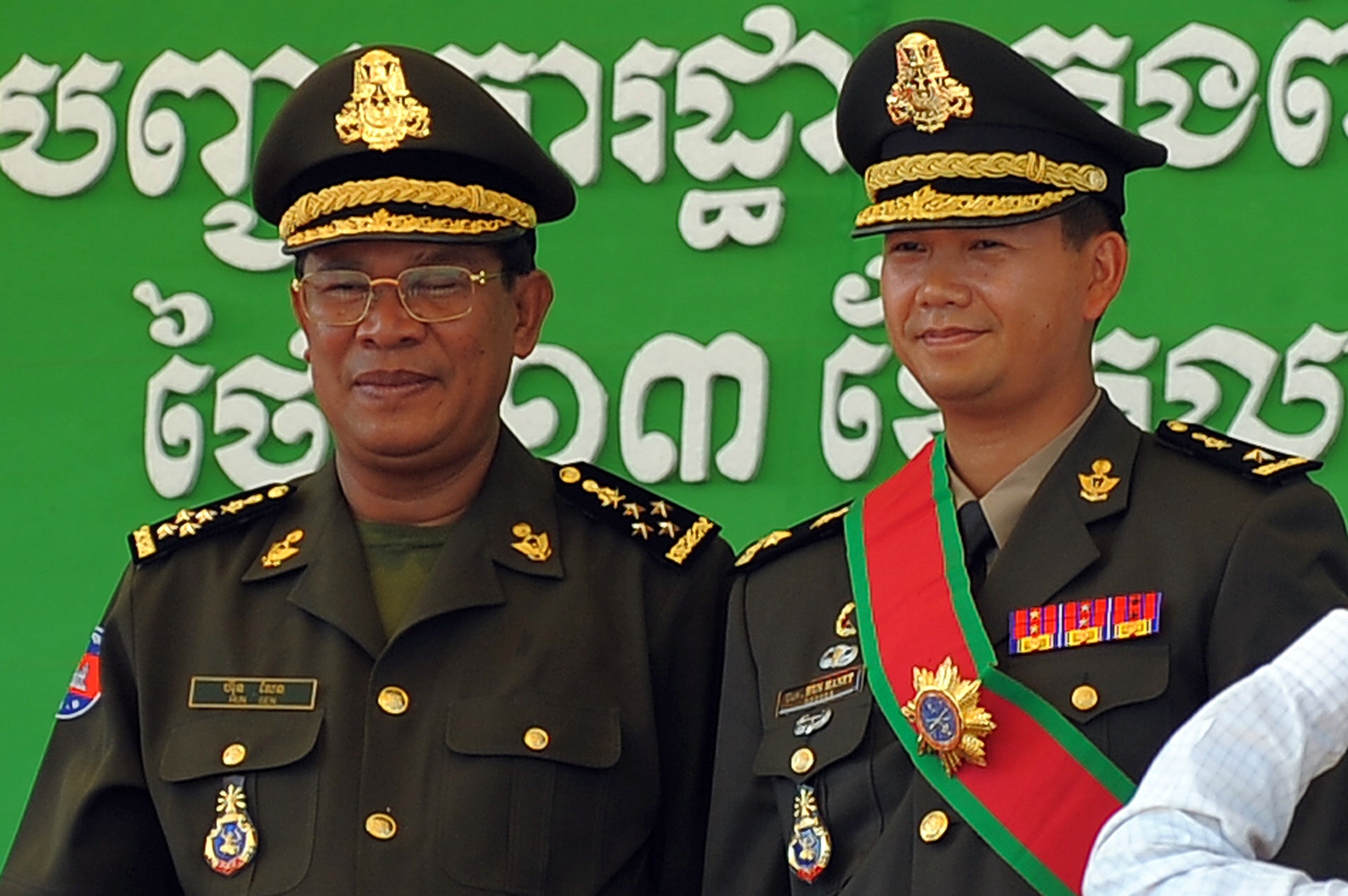 File: Cambodian prime minister Hun Sen (L) poses with his son Hun Manet (R) during a ceremony at a military base in Phnom Penh
