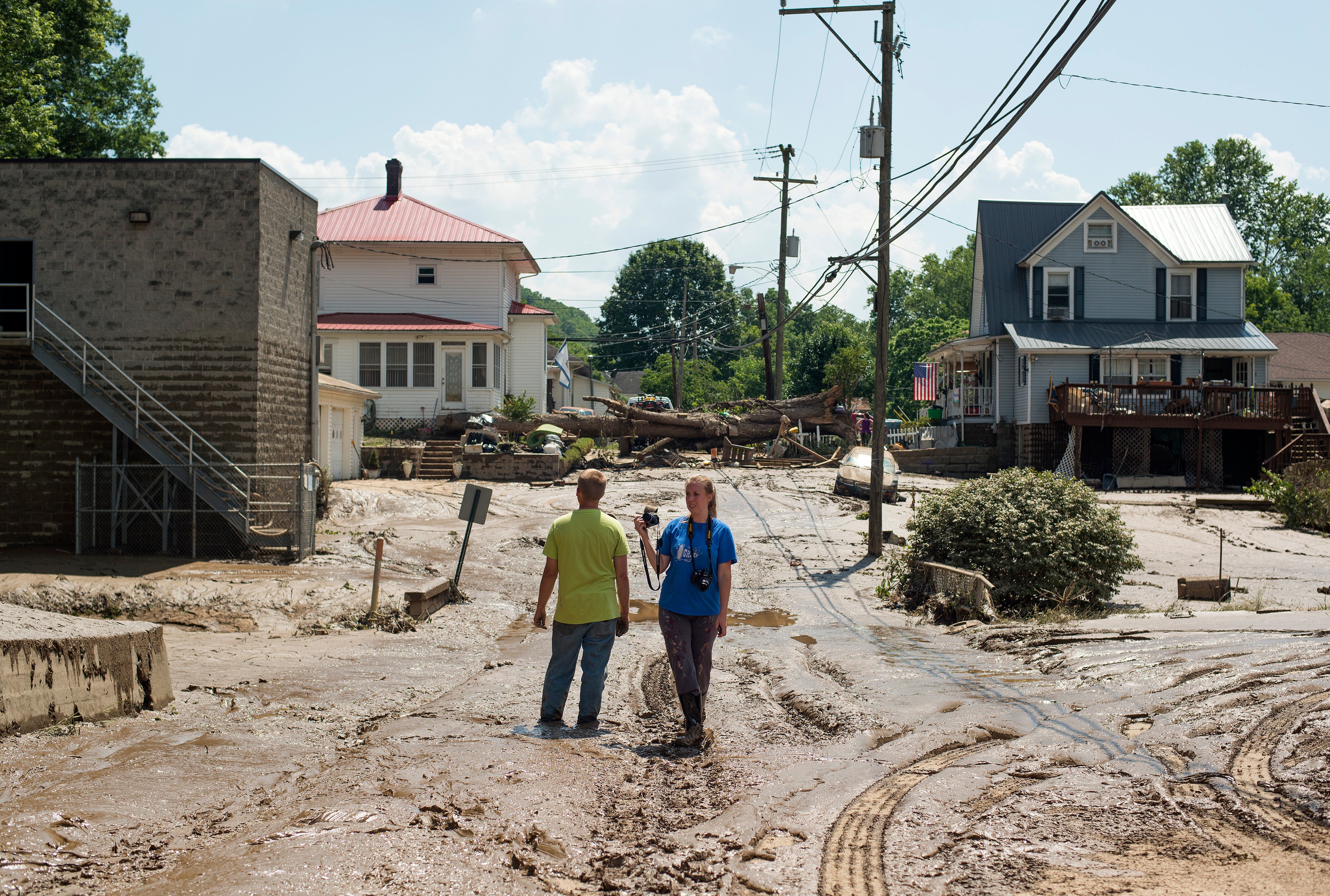 People on a mud-covered street after flooding in June 2016 in Clendenin, West Virginia. Floods claimed the lives of at least 23 people in West Virginia
