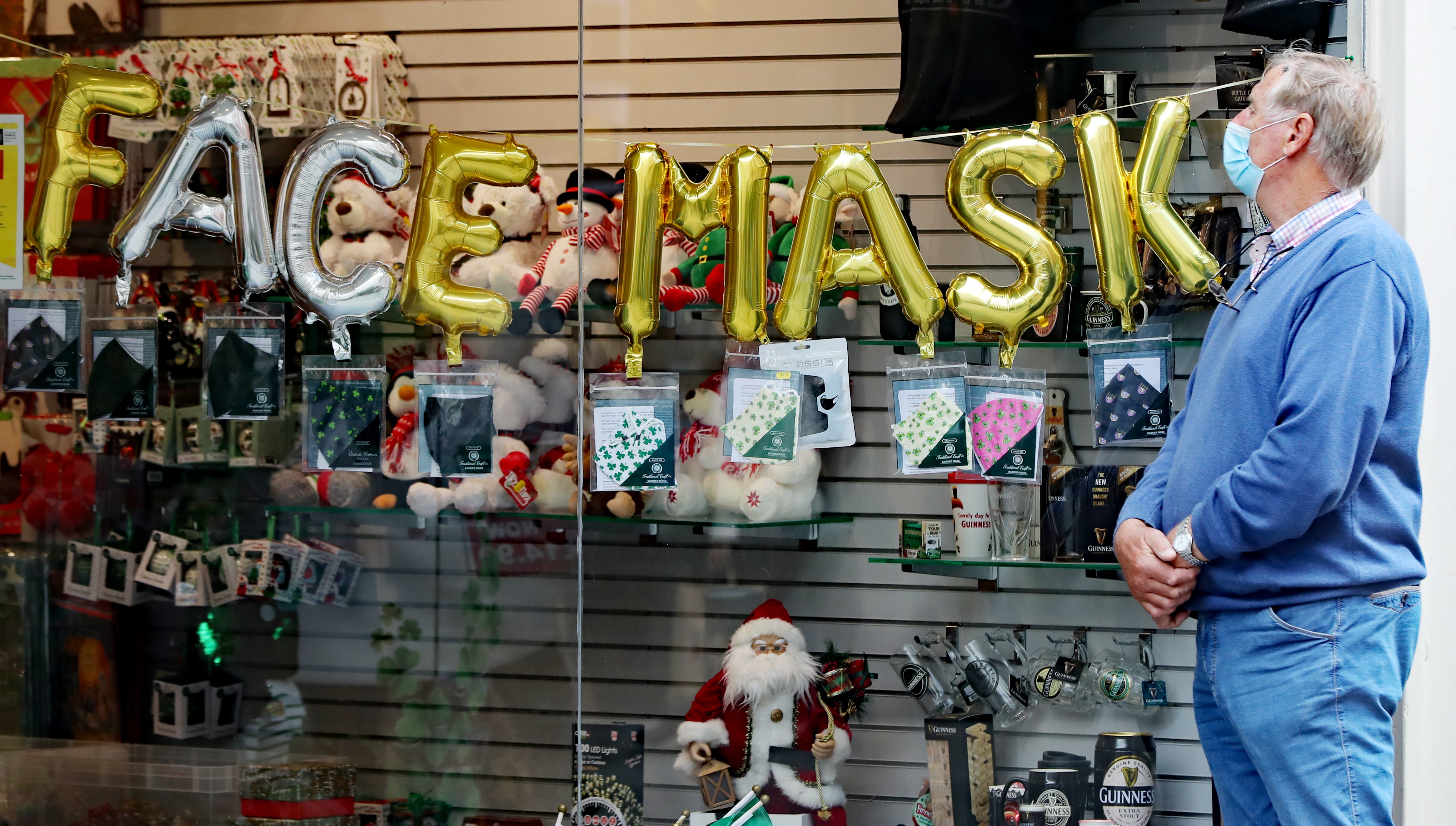 A man looks into a shop selling face masks in Dublin city centre (Niall Carson/PA)