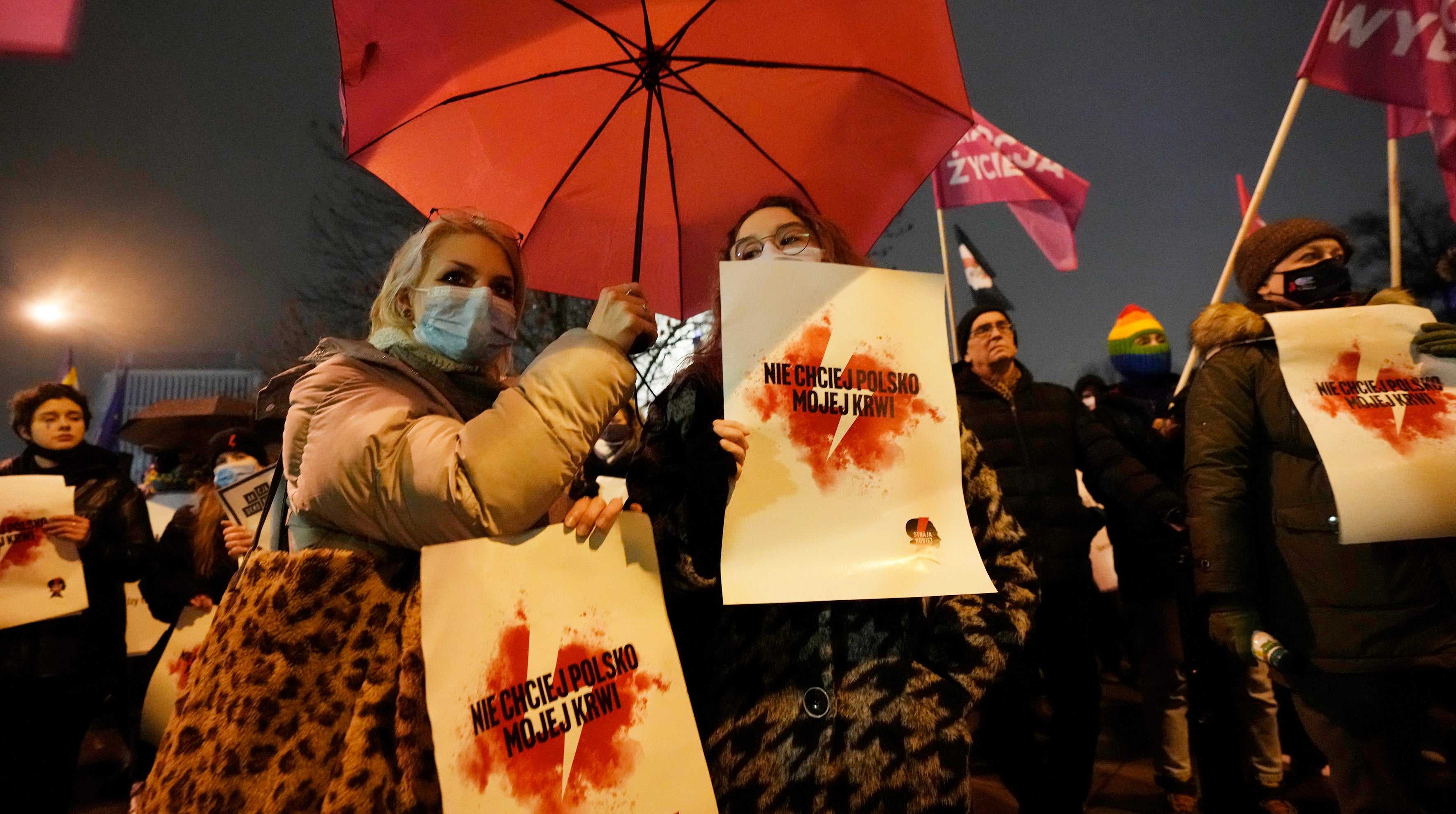 Women hold signs saying ‘Don’t ask for my blood, Poland’ in Polish capital of Warsaw