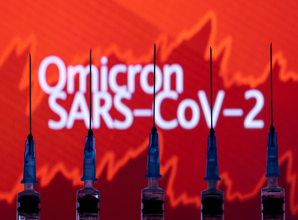<p>Syringes with needles are seen in front of a displayed stock graph and words "Omicron SARS-CoV-2" in this illustration taken, November 27, 2021</p>