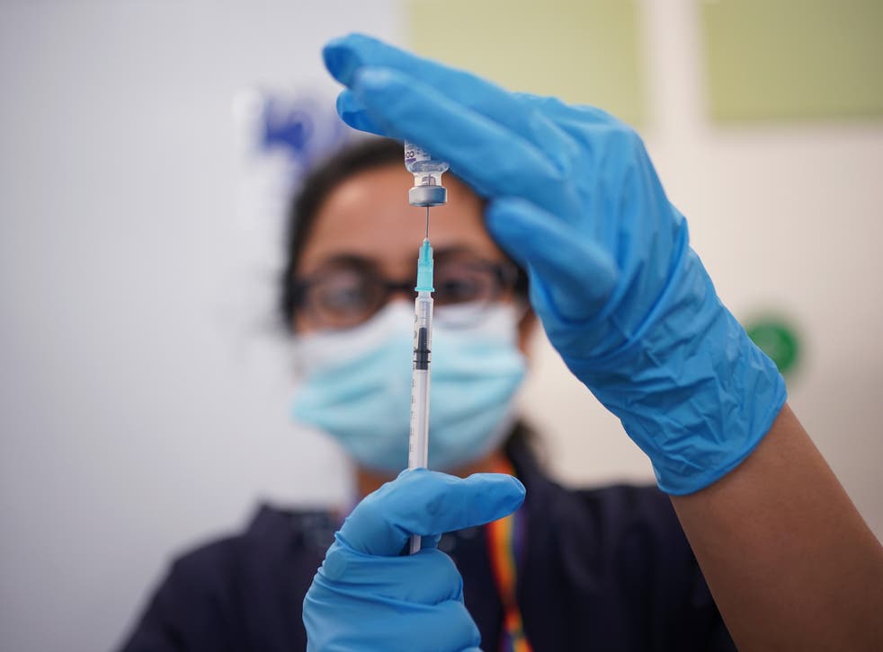 A nurse prepares a dose of the Pfizer Covid-19 vaccination at a vaccination site in Liberty Shopping Centre, Romford, east London, as the Government accelerates the Covid booster programme (Yui Mok/PA)