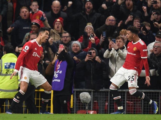 <p>Cristiano Ronaldo celebrates scoring from the penalty spot with Jadon Sancho</p>