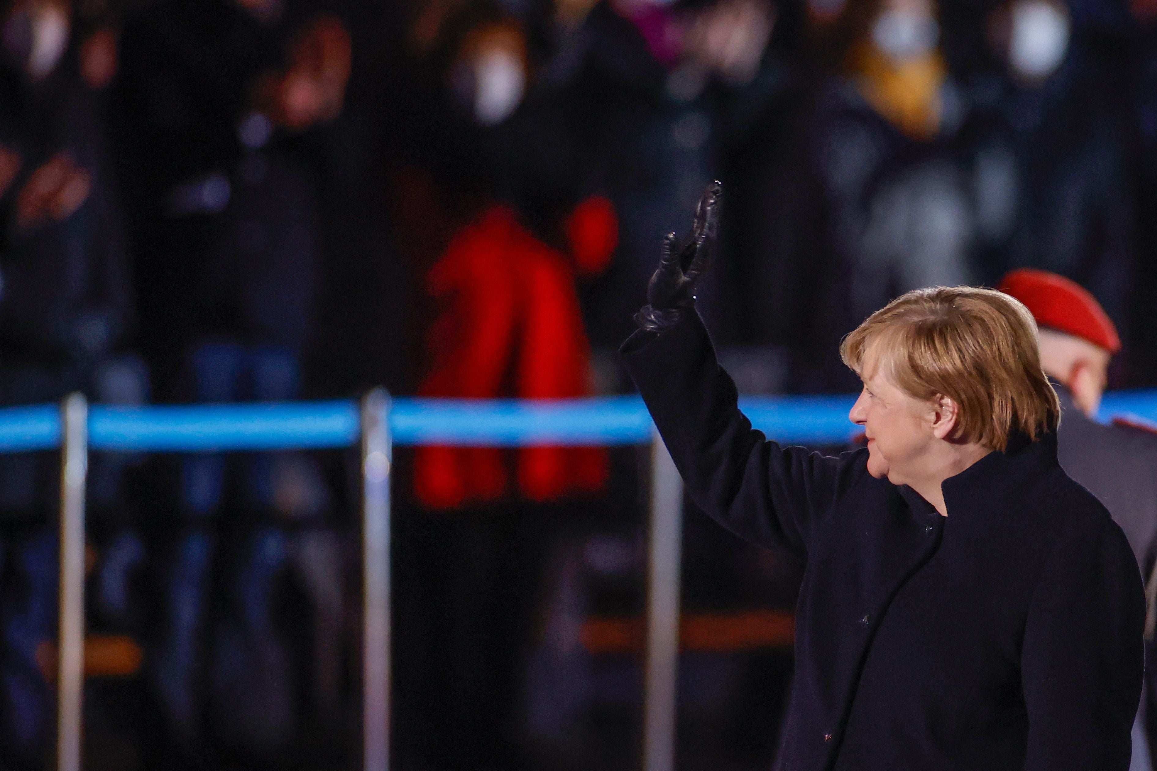 German Chancellor Angela Merkel waves goodbye at the Defence Ministry during her ceremonial send-off for her in Berlin