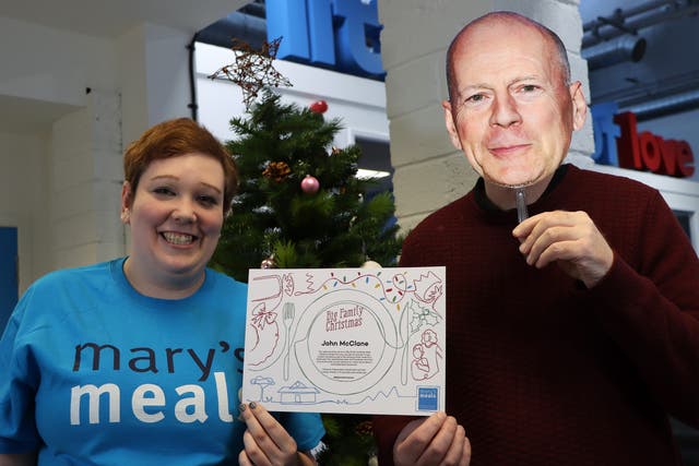 Morven Macgillivray, supporter engagement manager at Mary’s Meals, presenting ‘John McClane’ with a Big Family Christmas certificate (Mary’s Meals/PA)