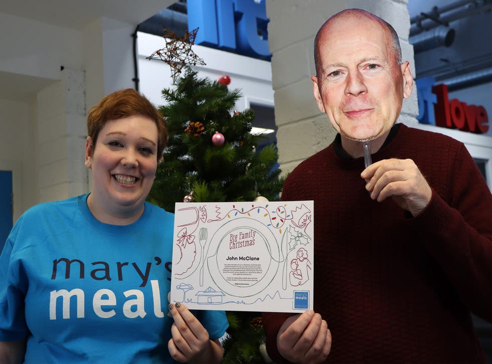 Morven Macgillivray, supporter engagement manager at Mary’s Meals, presenting ‘John McClane’ with a Big Family Christmas certificate (Mary’s Meals/PA)