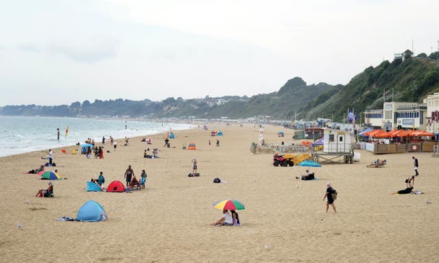 <p>People on Bournemouth beach in Dorset</p>