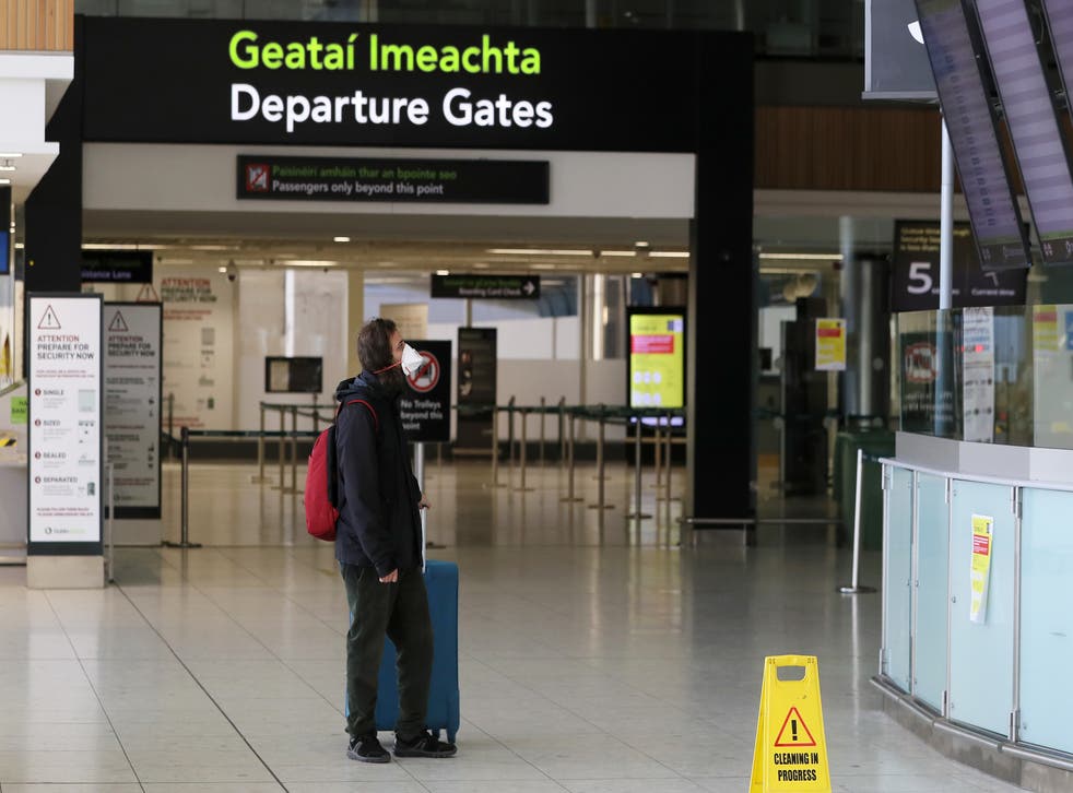A man wearing a protective face mask in the departures area of terminal one at Dublin airport (Brian Lawless/PA)