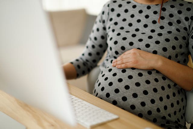<p>A pregnant woman at work</p>