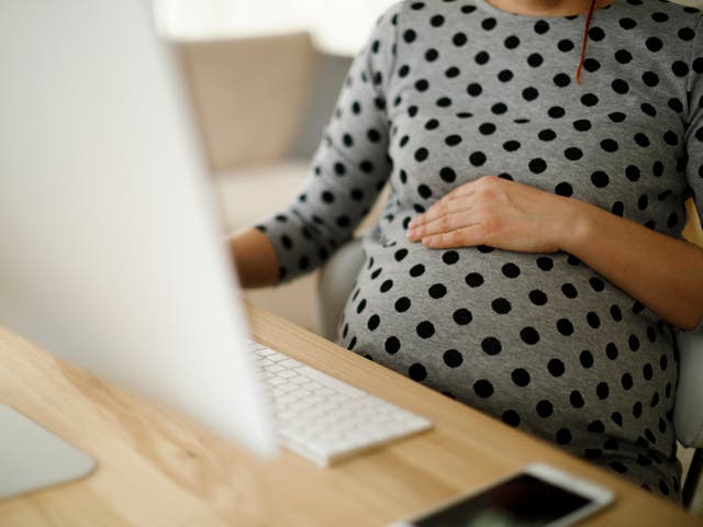 <p>A pregnant woman at work</p>