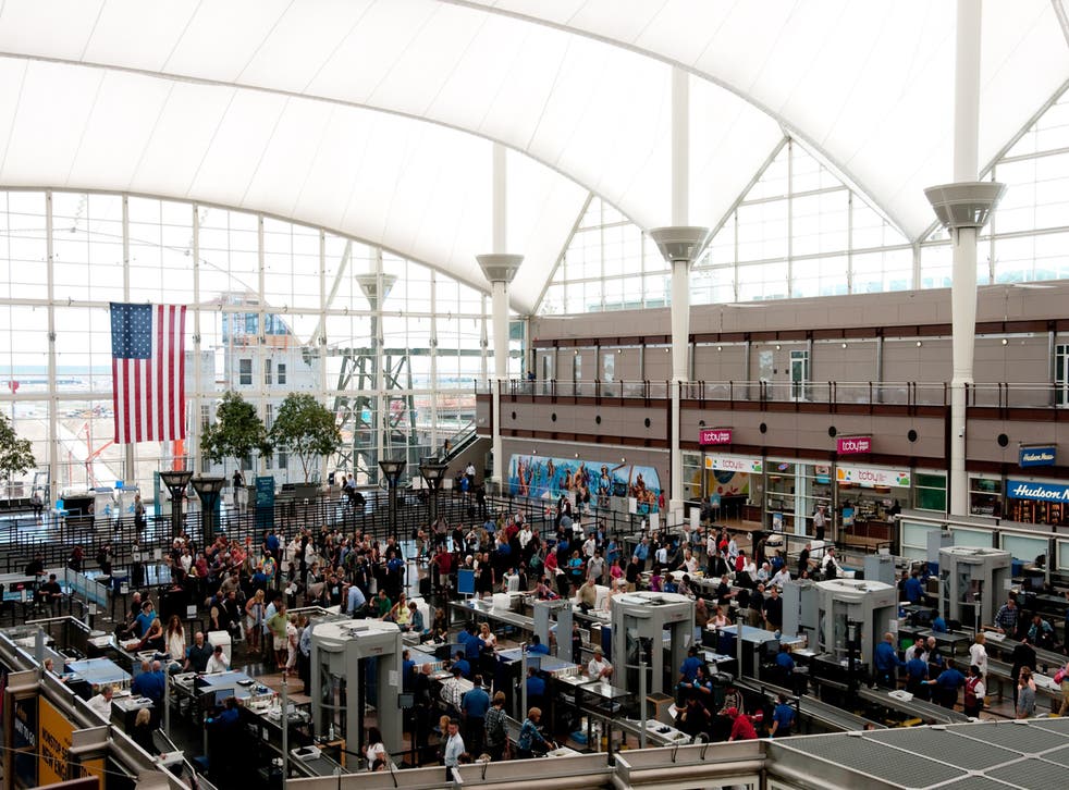 <p>Tourists moving through security at Denver International Airport</p>