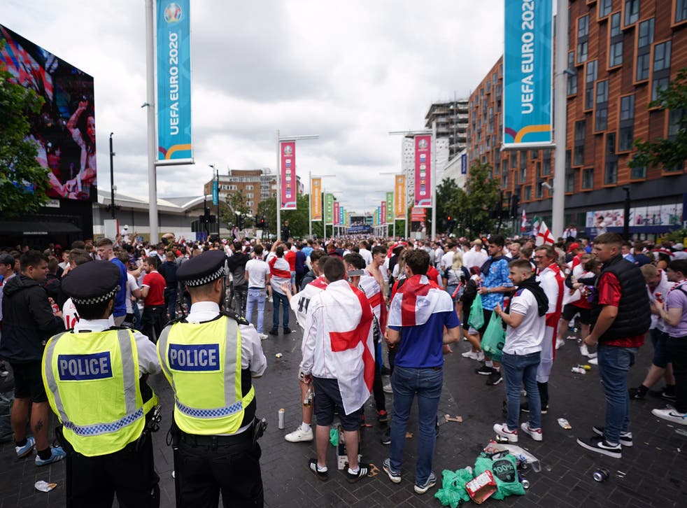 Police watch England fans outside Wembley ahead of the Euro 2020 final (Zac Goodwin/ PA)