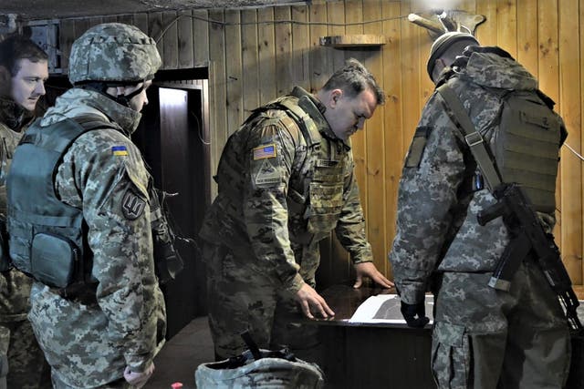 <p>Attache of the Land Forces at the US Embassy in Ukraine Colonel Brandon Presley looks at the map during the visit by a delegation of the US Embassy in Ukraine to the Joint Forces operation area in the war-hit Donetsk region</p>