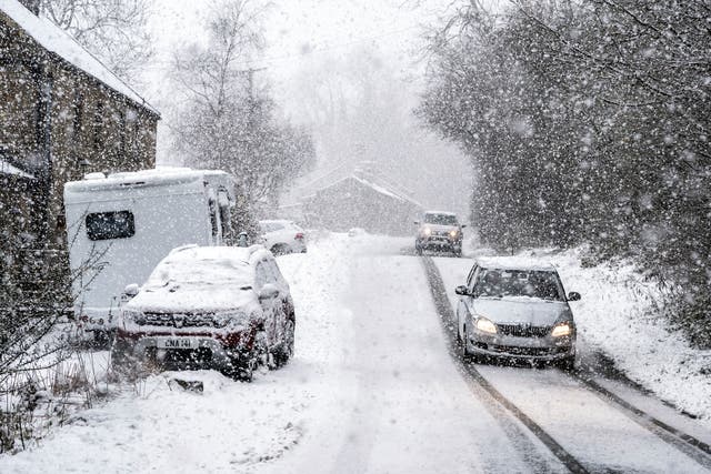 <p>Cars drive through the snow in Gunnerside, North Yorkshire in late November </p>