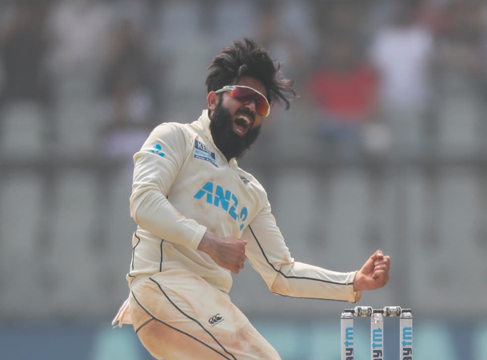 Ajaz Patel celebrates the dismissal of India’s Mohammed Siraj to complete his 10-wicket haul (Rafiq Maqbool/AP)
