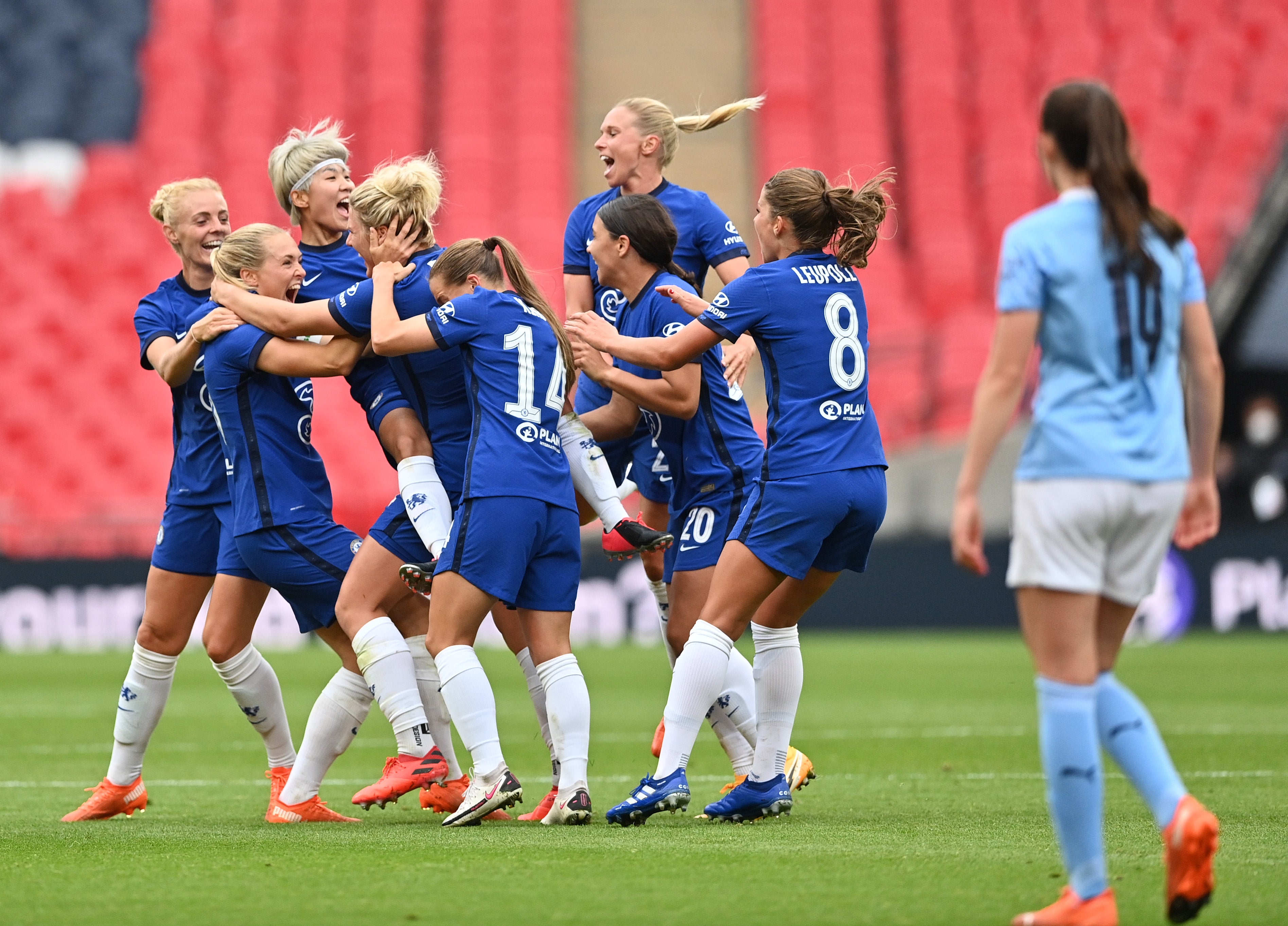 Millie Bright is surrounded by her teammates after scoring at an empty Wembley