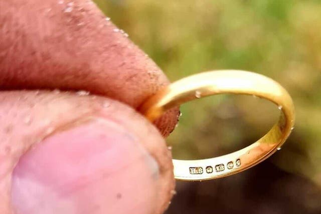 <p>Donald MacPhee holds up Peggy MacSween’s ring that he found with a metal detector, 50 years after she lost it in a potato patch</p>