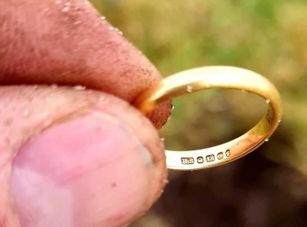 <p>Donald MacPhee holds up Peggy MacSween’s ring that he found with a metal detector, 50 years after she lost it in a potato patch</p>