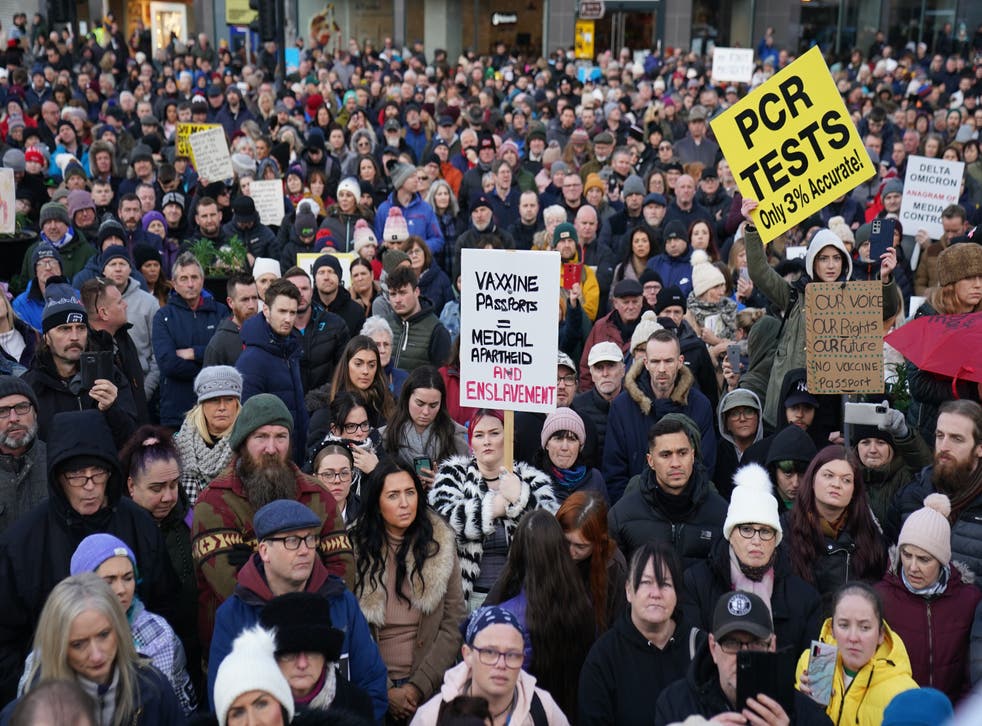 Demonstrators against the new Covid certification system protest outside Belfast City Hall (Brian Lawless/PA)
