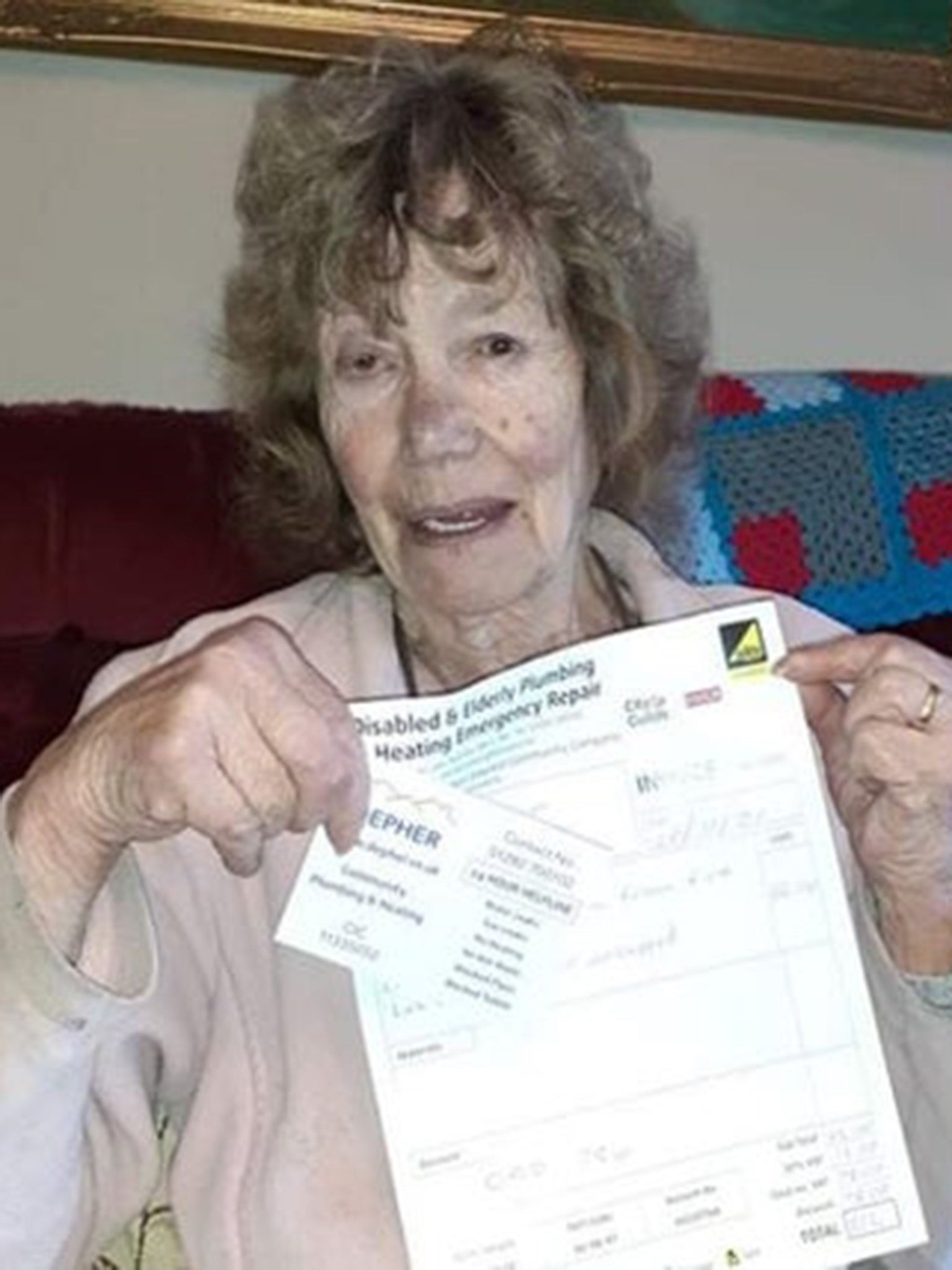 A customer holds up her invoice for £0