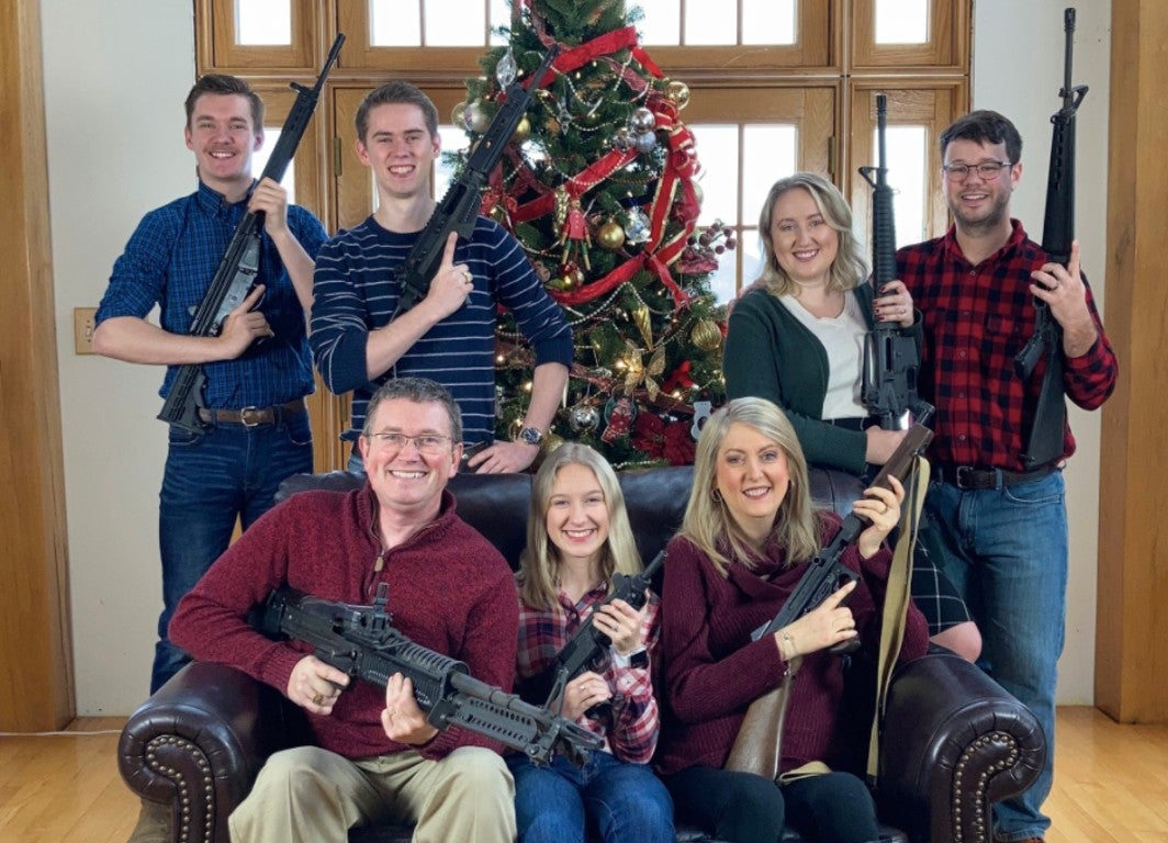 Thomas Massie pictured with his family posing with a selection of firearms