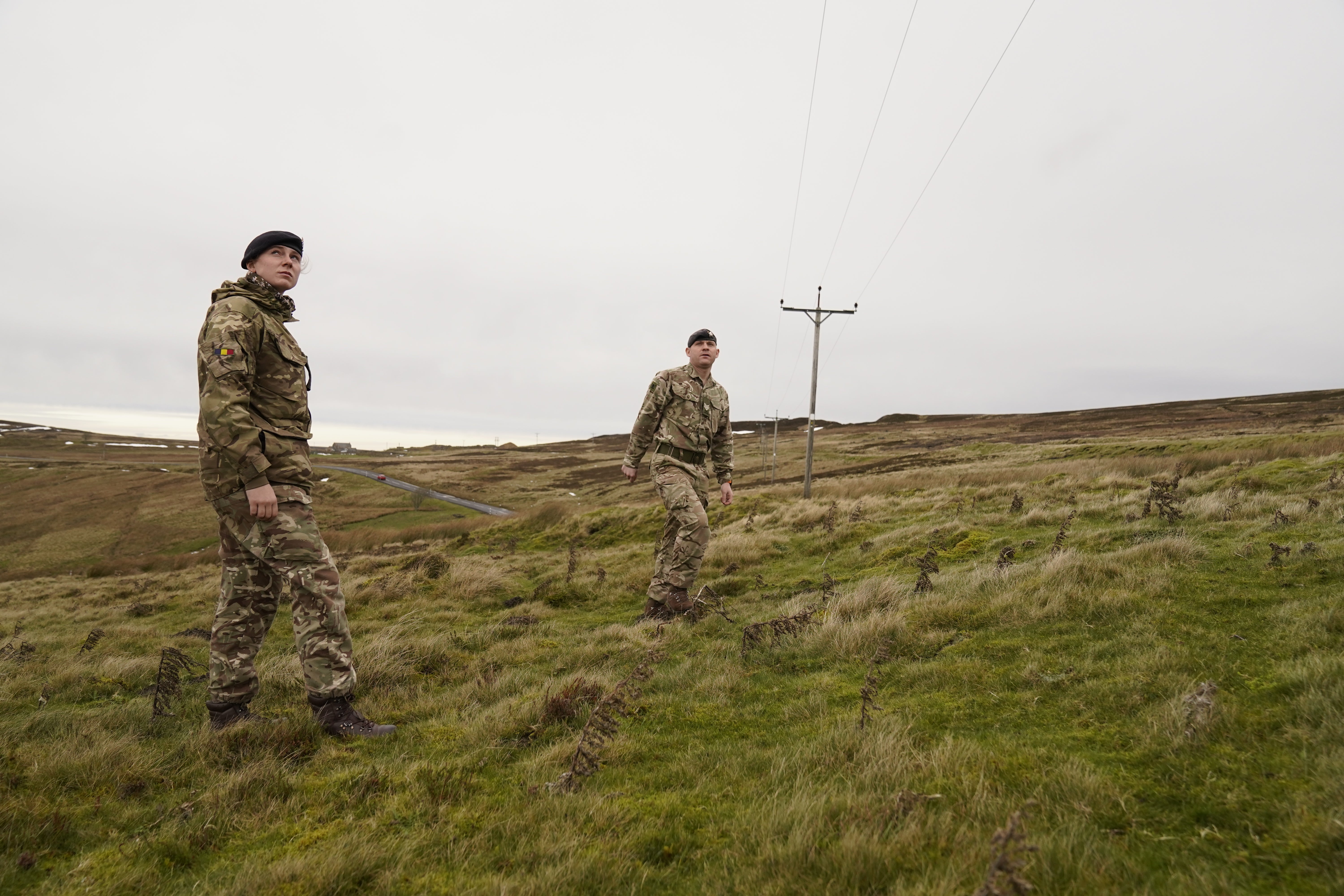 Members of the armed forces check on overhead power cables (Danny Lawson/PA)