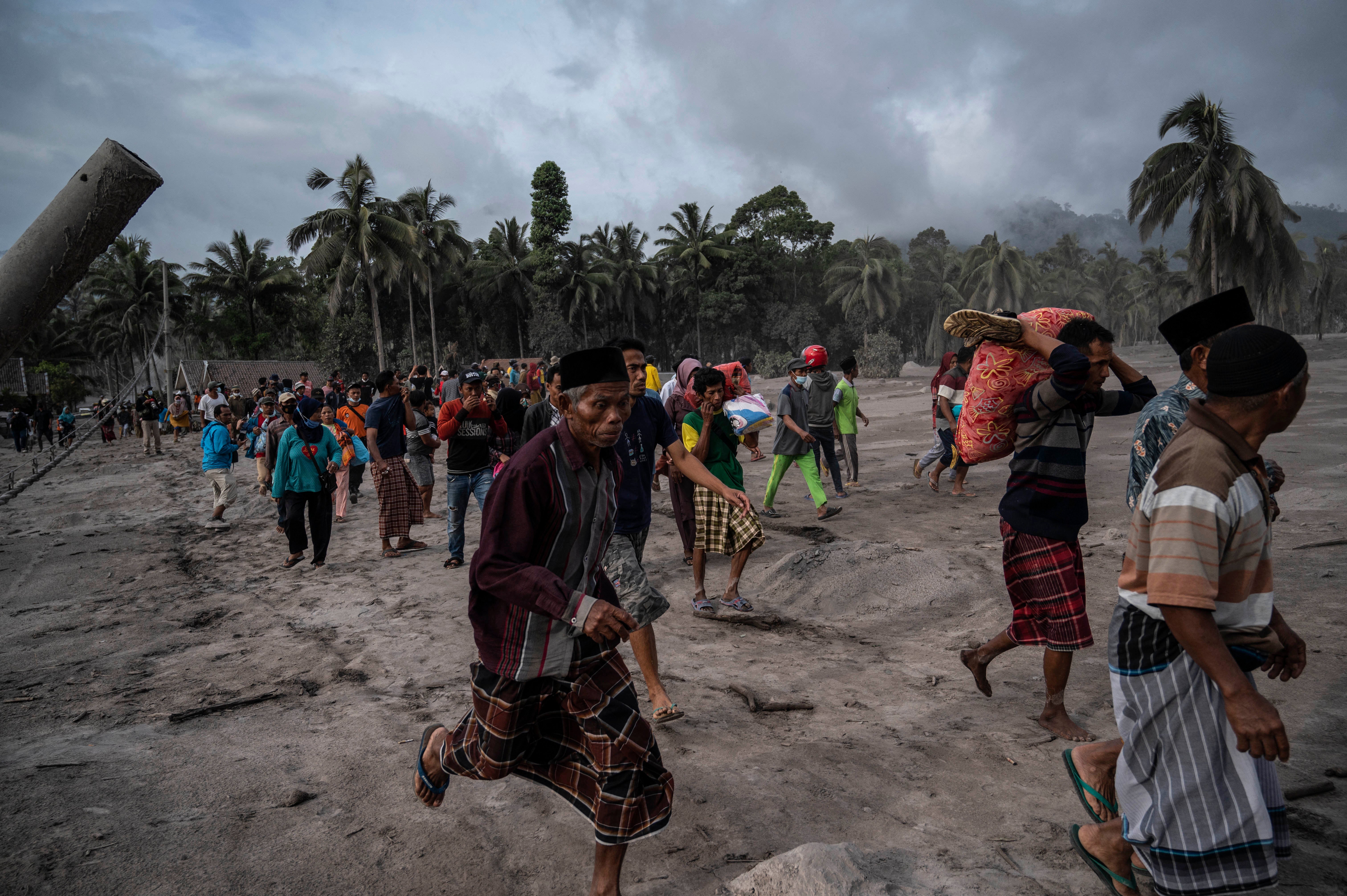 Villagers salvage their belongings in an area covered in volcanic ash at Sumber Wuluh village in Lumajang
