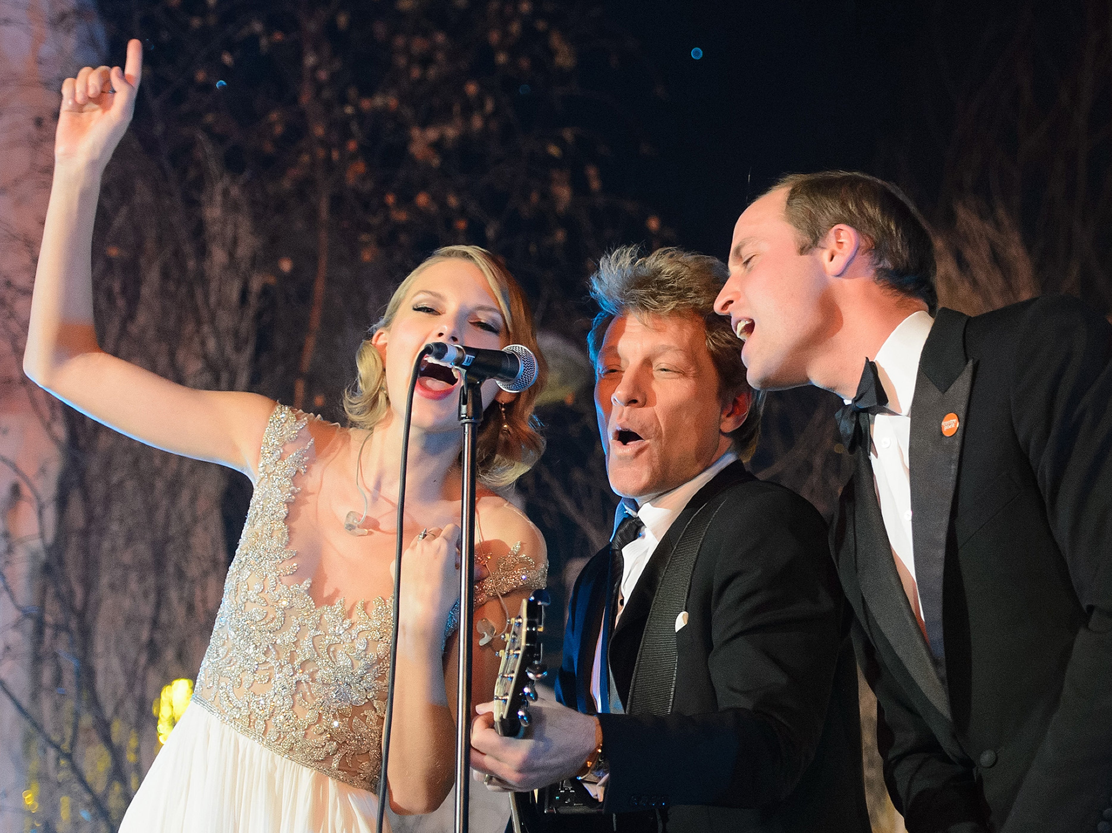 Prince William, Duke of Cambridge, (R) sings with Taylor Swift (L) and Jon Bon Jovi (C) at the Centrepoint Gala Dinner at Kensington Palace in 2013
