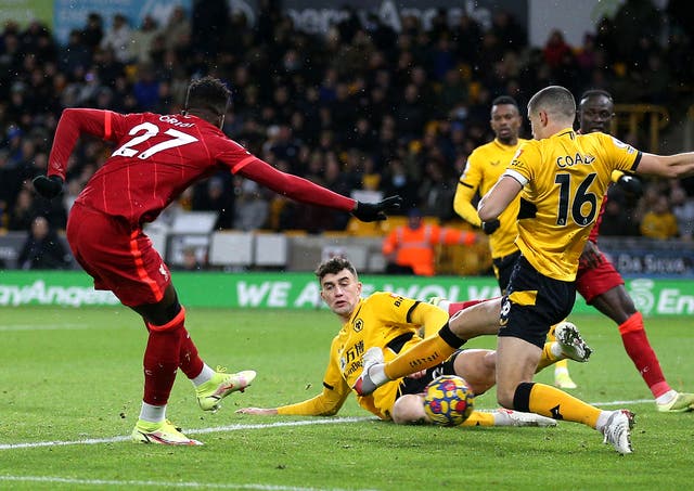 Divock Origi scores Liverpool’s injury-time winner at Wolves (Nigel French/PA)