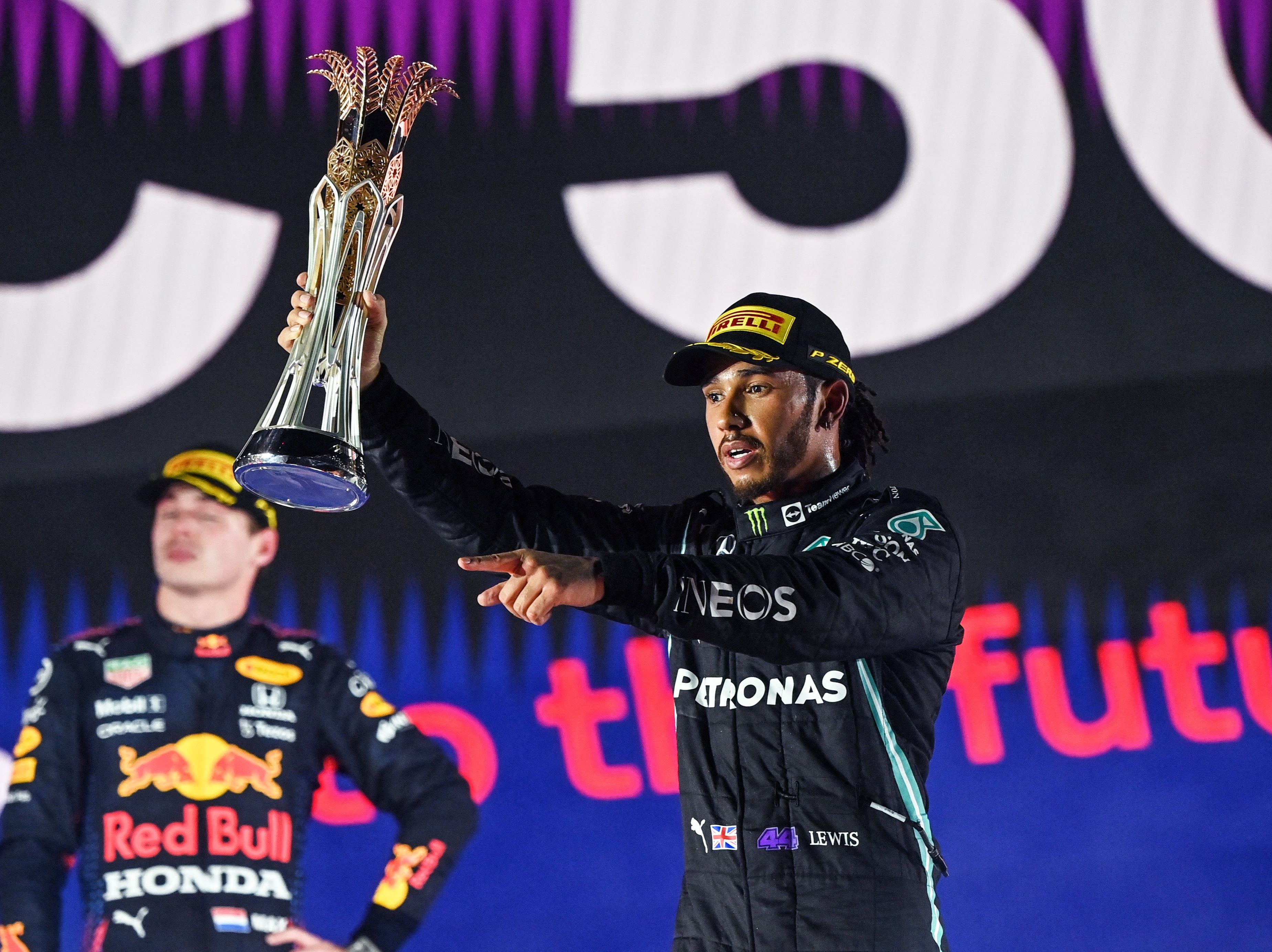 Lewis Hamilton celebrates winning the Saudi Arabian Grand Prix, flanked by title rival Max Verstappen