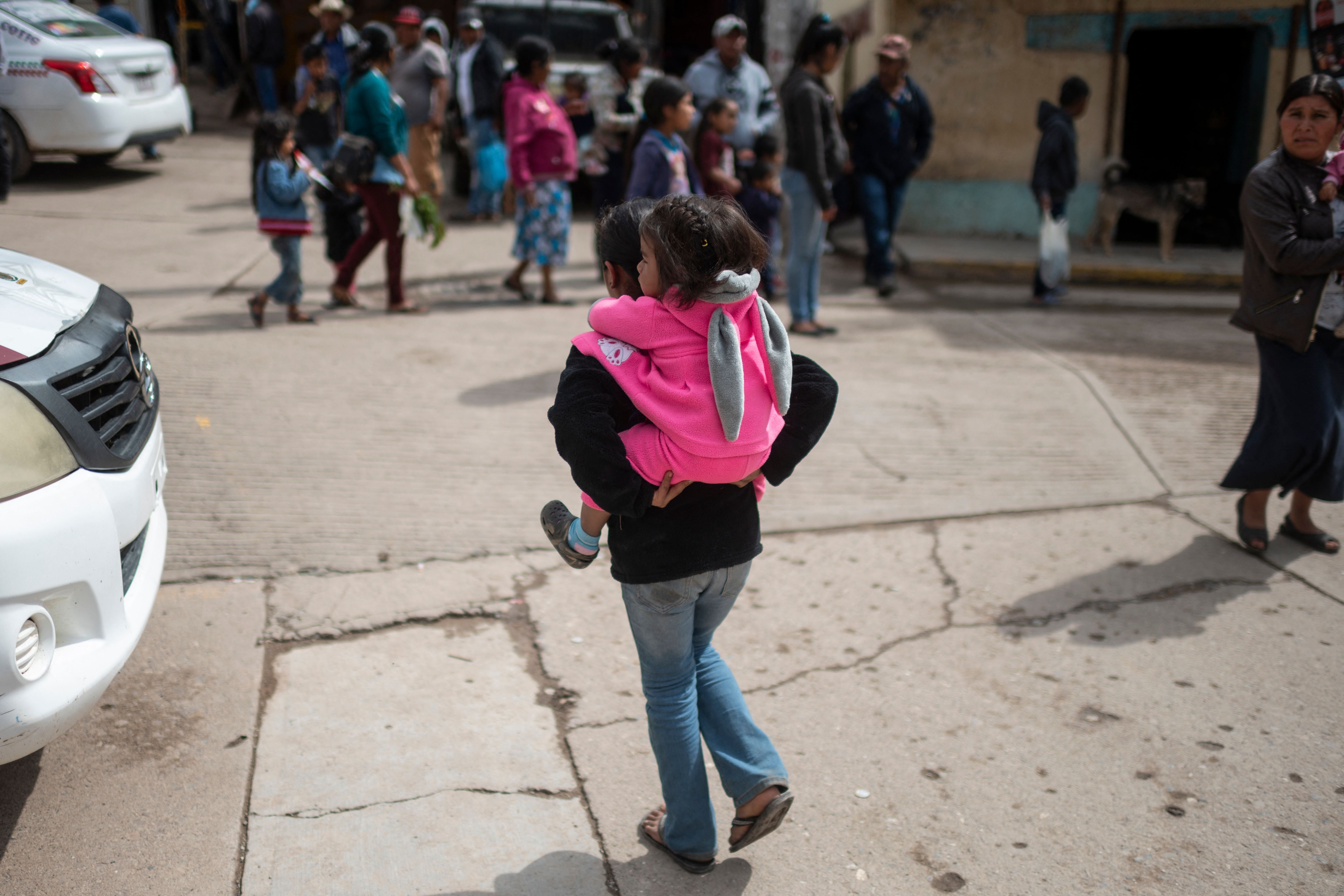File image: A woman carries a child in Guerrero state, Mexico, on May 16, 2021, where girls are given in marriage under an ancestral agreement of buying and selling