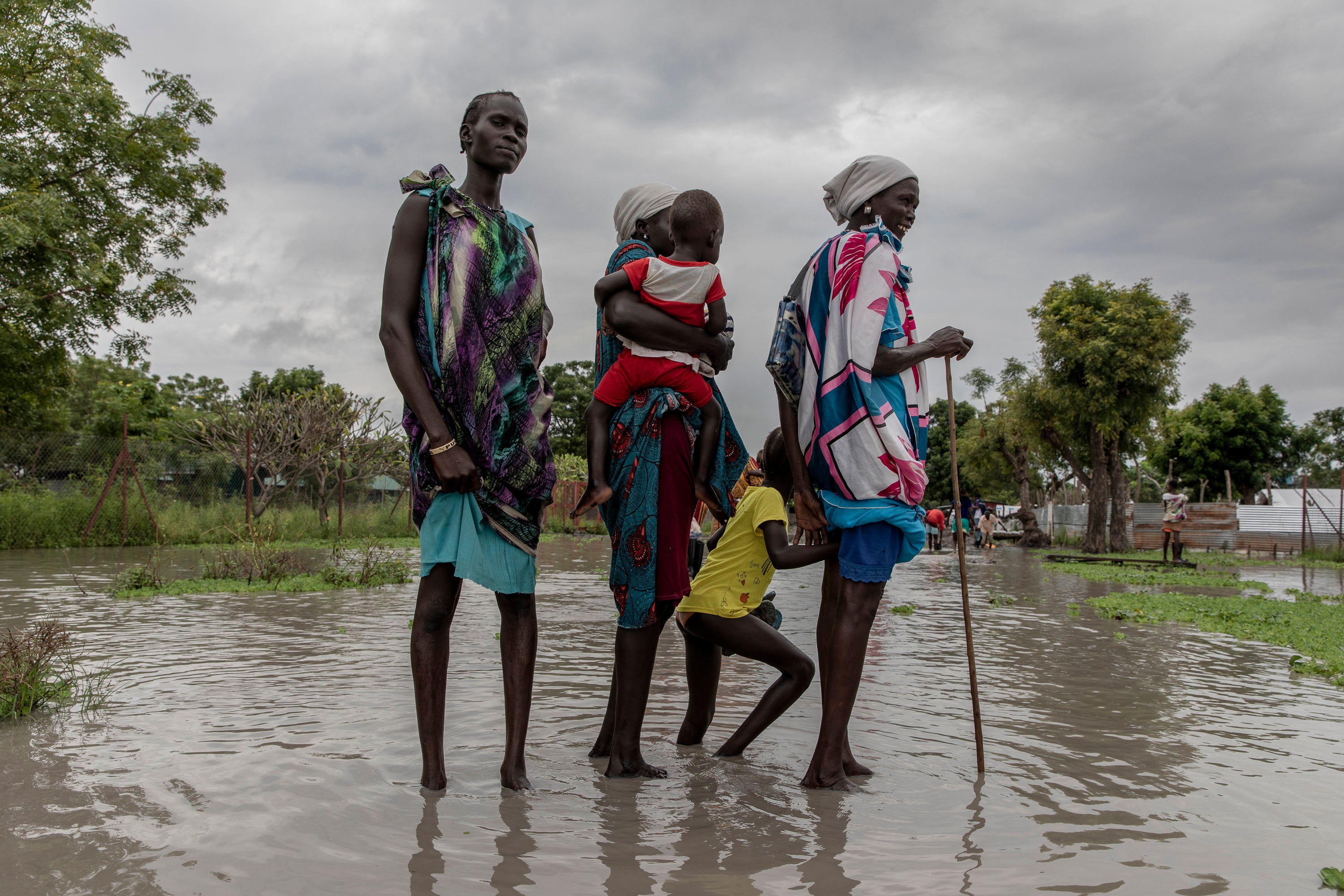 Martha Nyakoang and her family walk for an hour in in waist-high water to get to church in Old Fangak, South Sudan