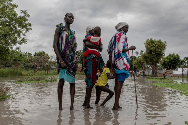 <p>Martha Nyakoang and her family walk for an hour in in waist-high water to get to church in Old Fangak, South Sudan</p>