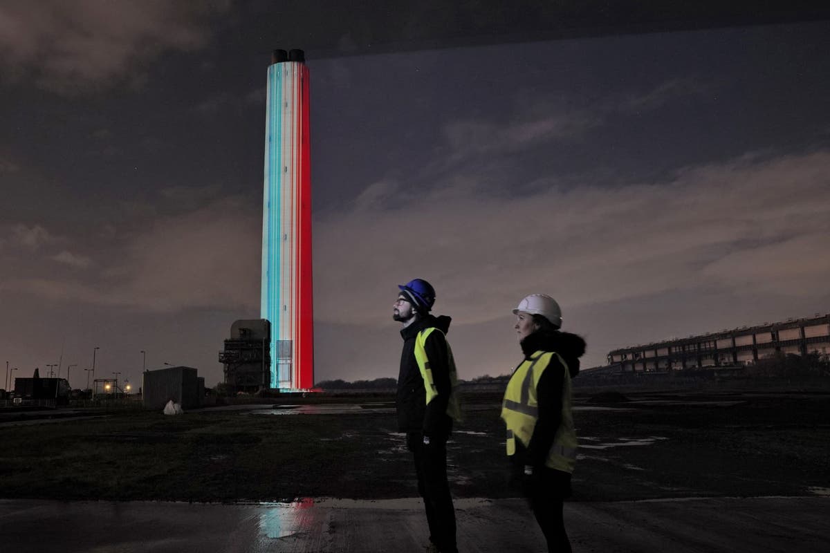 Environmental message projected onto power station chimney ahead of demolition