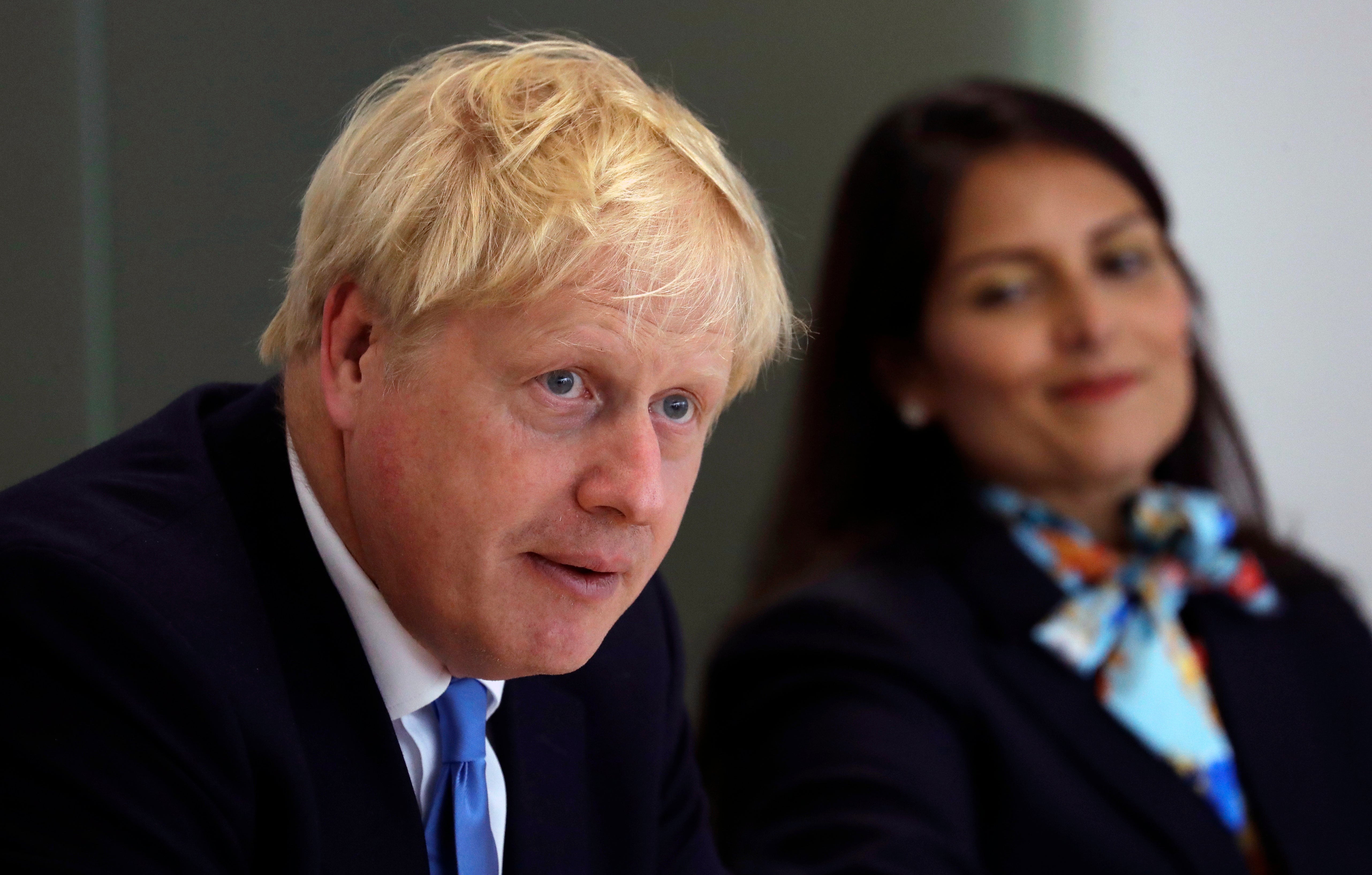 Prime Minister Boris Johnson with Home Secretary Priti Patel during a meeting of the National Policing Board in 2010 (PA)