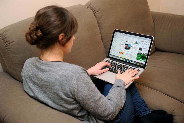 A woman uses a laptop to browse the internet (PA)