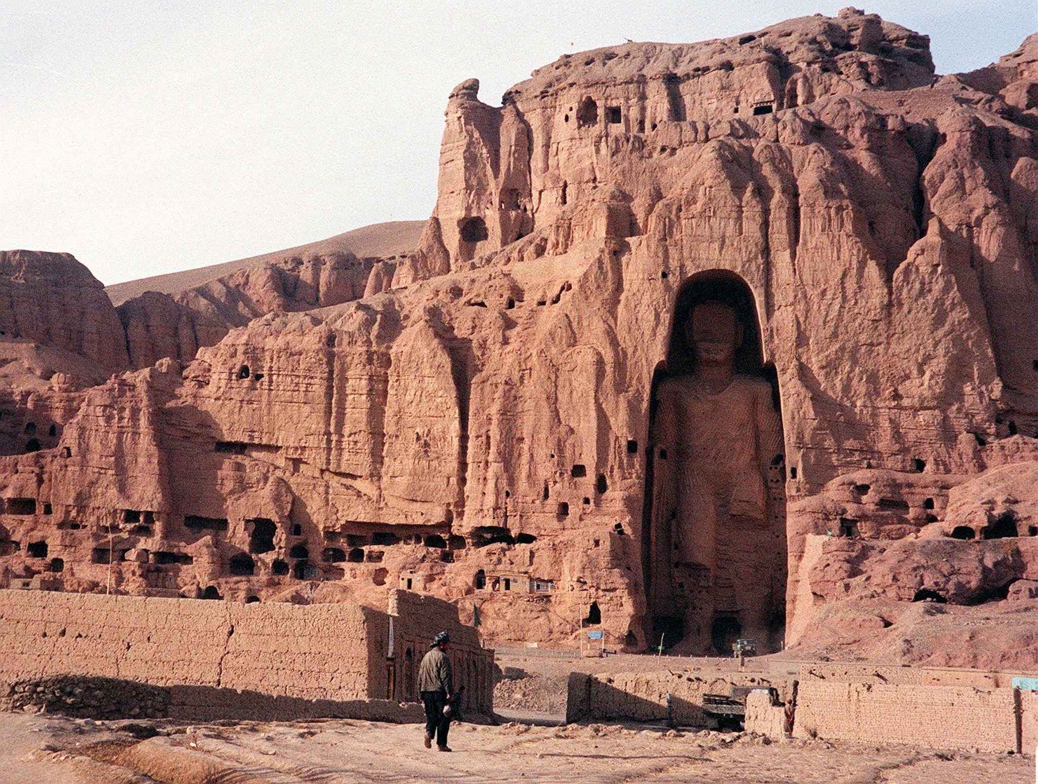 A file photo dated 07 December 1997 shows an Afghan walking near the world's tallest standing statue of Buddha in Bamiyan province of Afghanistan
