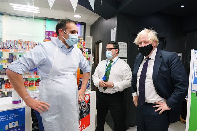 Prime Minister Boris Johnson meets staff during a visit to a pharmacy in the North Shropshire constituency ahead of the by-election following the resignation of Conservative MP Owen Paterson (PA)