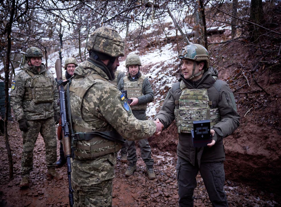 <p>Ukrainian President Volodymyr Zelenskyy, right, awards a soldier in a trench as he visits the war-hit Donetsk region, eastern Ukraine, Monday, Dec. 6, 2021. (Ukrainian Presidential Press Office via AP)</p>