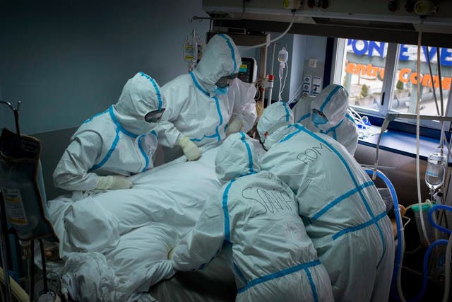 <p>File photo: Medics help a patient with coronavirus at the Intensive Care Unit (ICU) of the Cosaga Hospital in Ourense, Galicia</p>