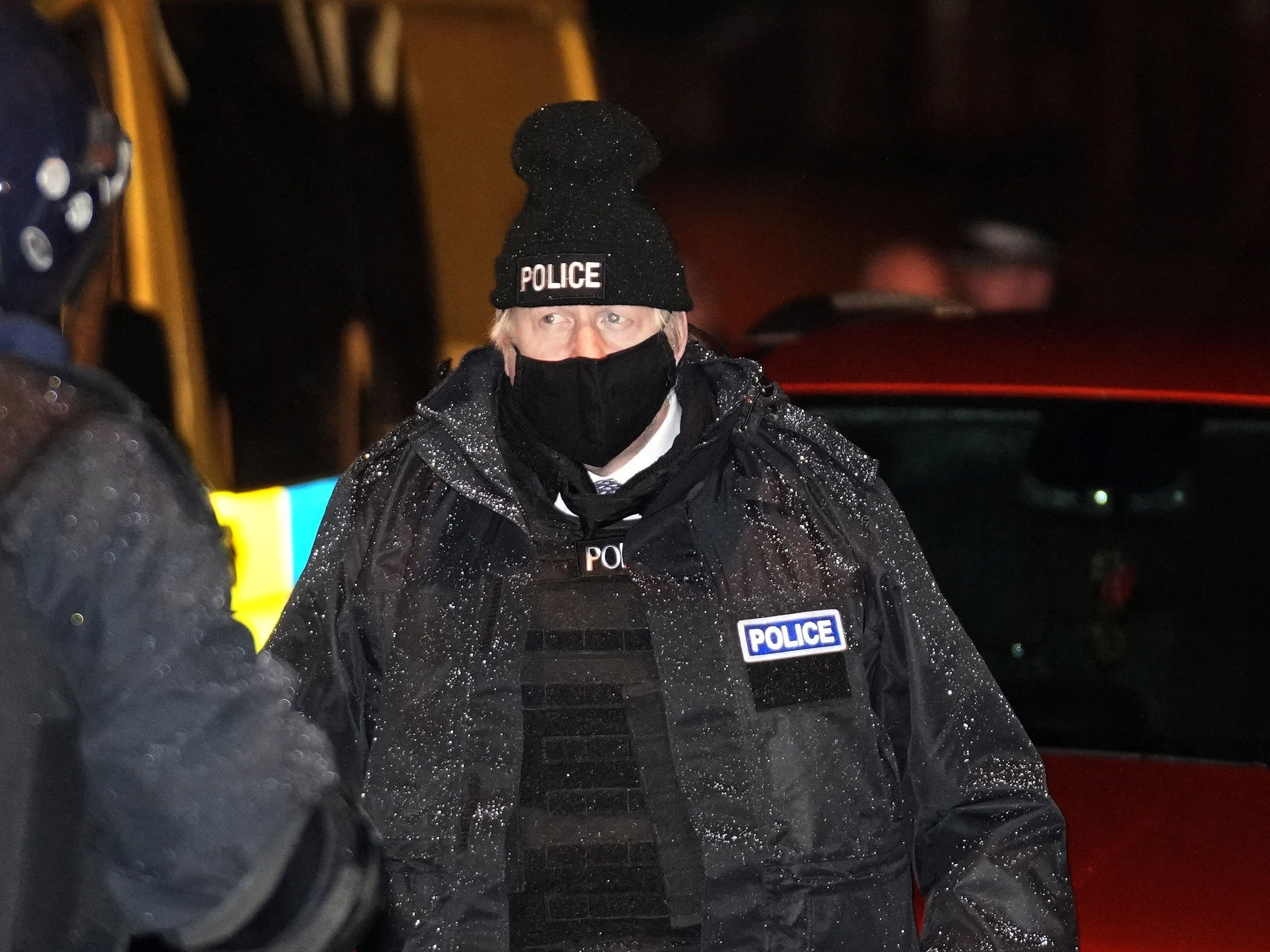 The plod of small things: Johnson dresses in police gear as he observes an early morning raid by Merseyside Police