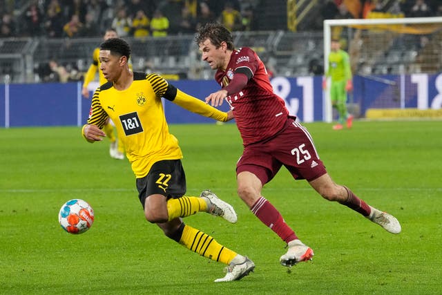 Jude Bellingham, left, played the full 90 minutes in Borussia Dortmund’s defeat to Bayern Munich (Martin Meissner/AP)