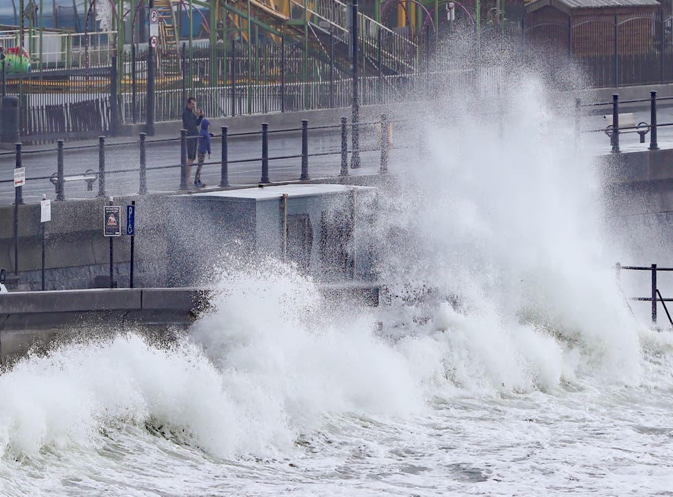 Waves crashing into the seafront at Tramore in County Waterford (Niall Carson/PA)