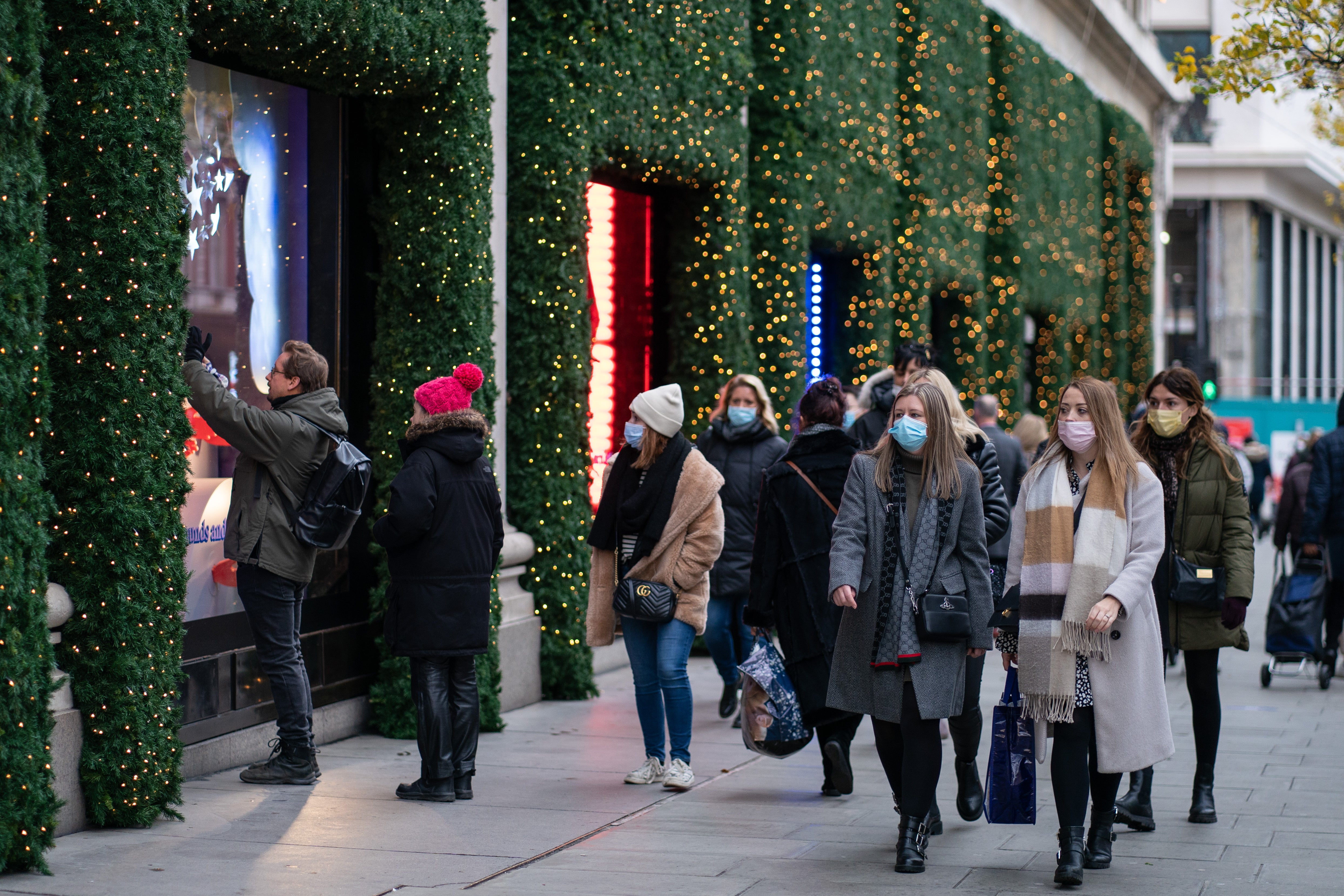 Shoppers look for gifts in Oxford Street as fears continue over the Omicron variant (PA)