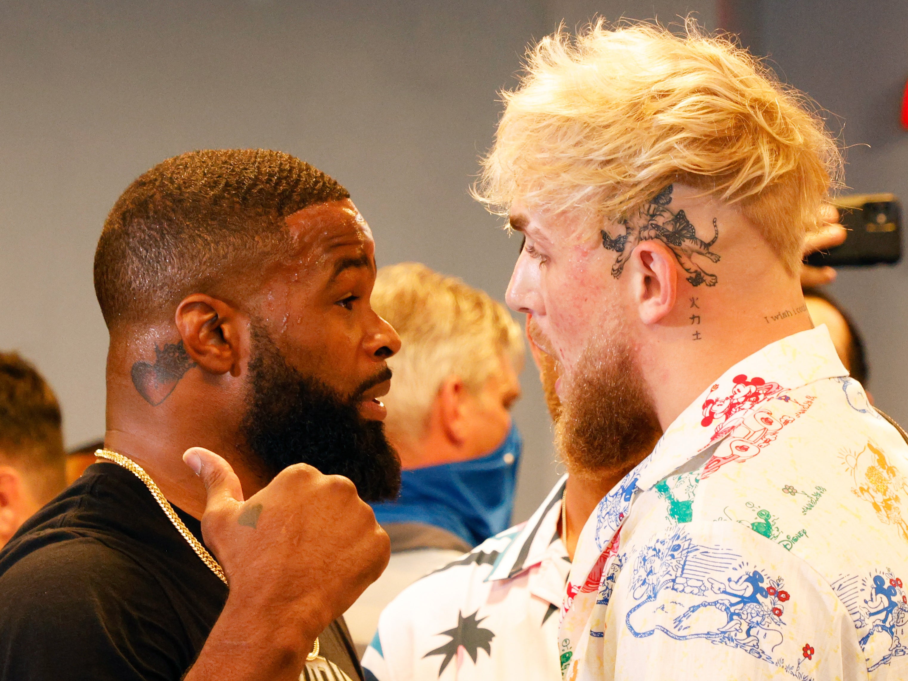 Tyron Woodley (left) faces off with Jake Paul ahead of their first clash
