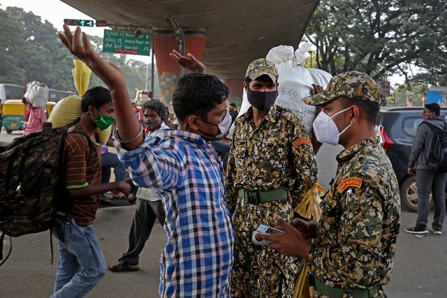<p>Marshals patrol the area looking for people not wearing a mask amid the ongoing pandemic in Karnataka state capital Bengaluru, where a case of the omicron variant was detected</p>