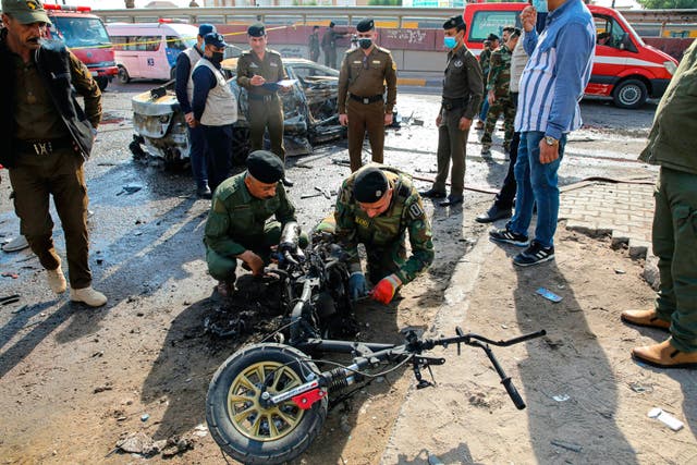 <p>Security forces inspect a motorcycle at the site of an explosion in Basra, Iraq</p>