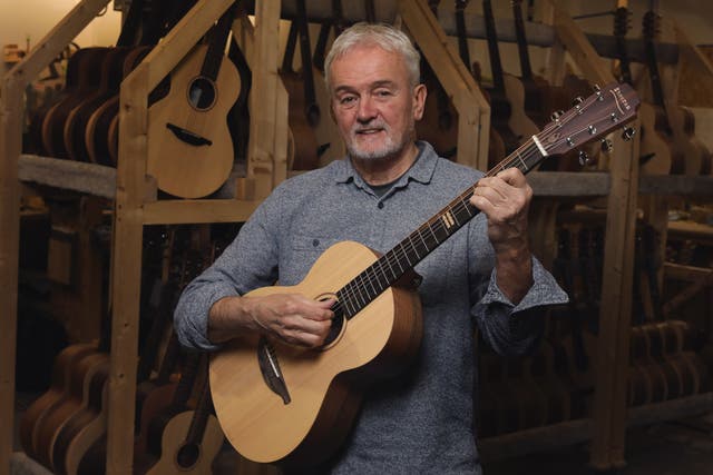 George Lowden of Lowden Guitars with the Sheeran by Lowden ‘Equals Edition’ guitar at his workshop in County Down, Northern Ireland (PA)