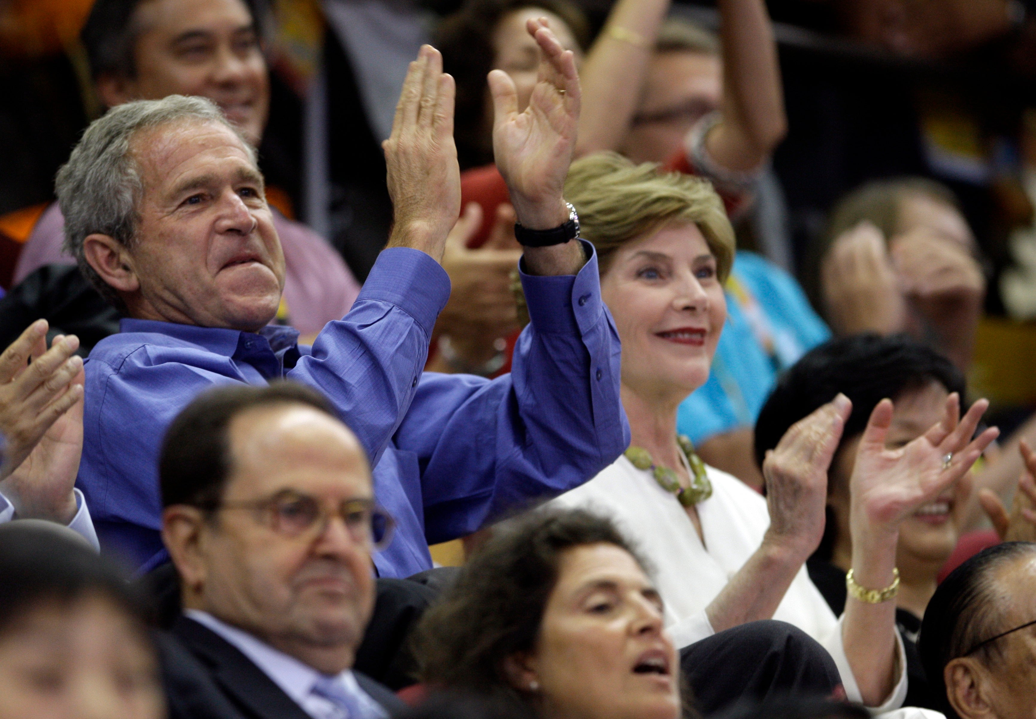 US President George W. Bush cheers at a basketball game at the Beijing 2008 Olympics