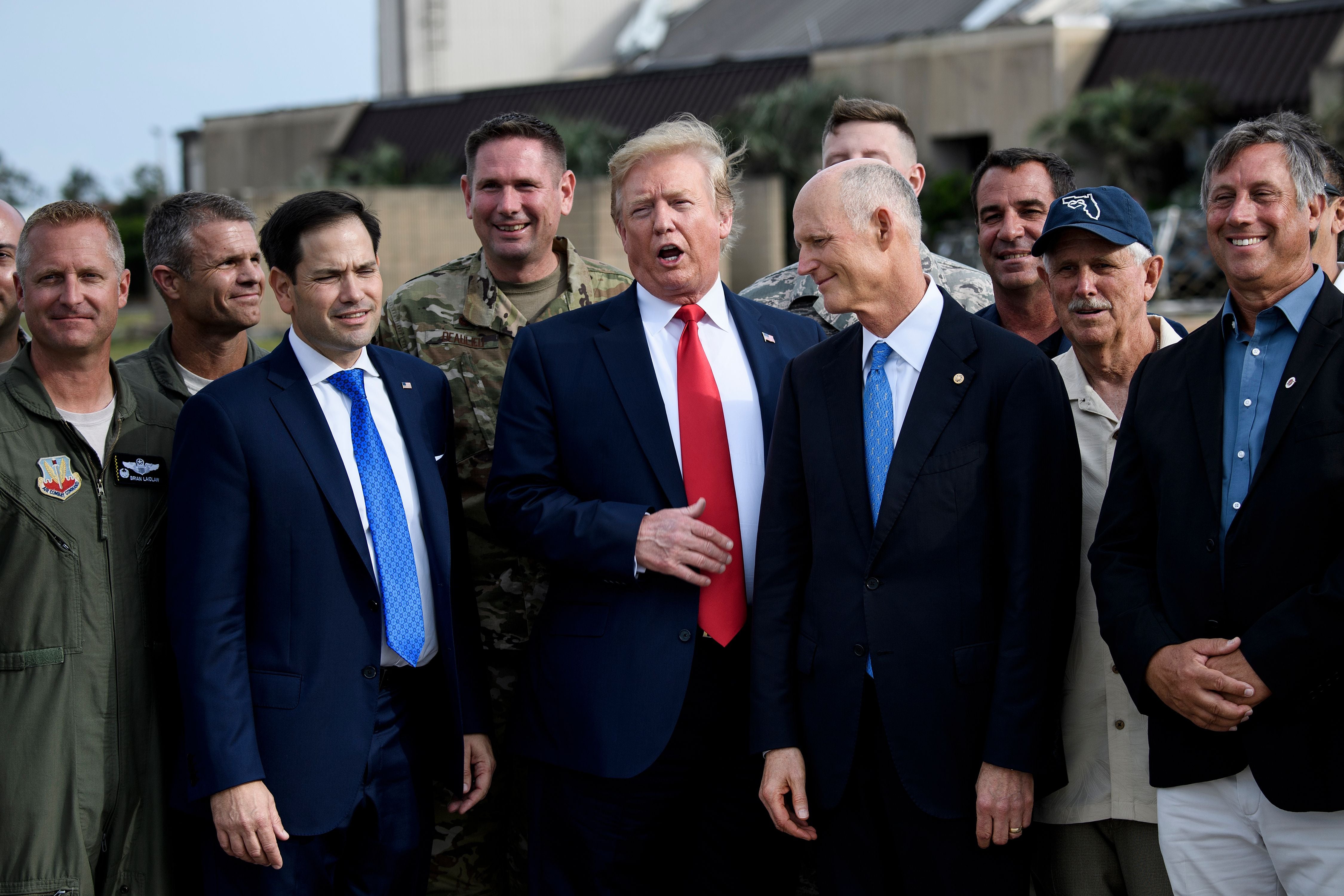 US President Donald Trump (C) looks on next to US Senators Marco Rubio (R-FL) (2L) and Rick Scott (R-FL) as he tours damage by Hurricane Michael at Tyndall Air Force Base, Florida on May 8, 2019. (Photo by Brendan Smialowski / AFP) (Photo credit should read BRENDAN SMIALOWSKI/AFP via Getty Images